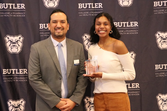 Butler University student with professor at ceremony