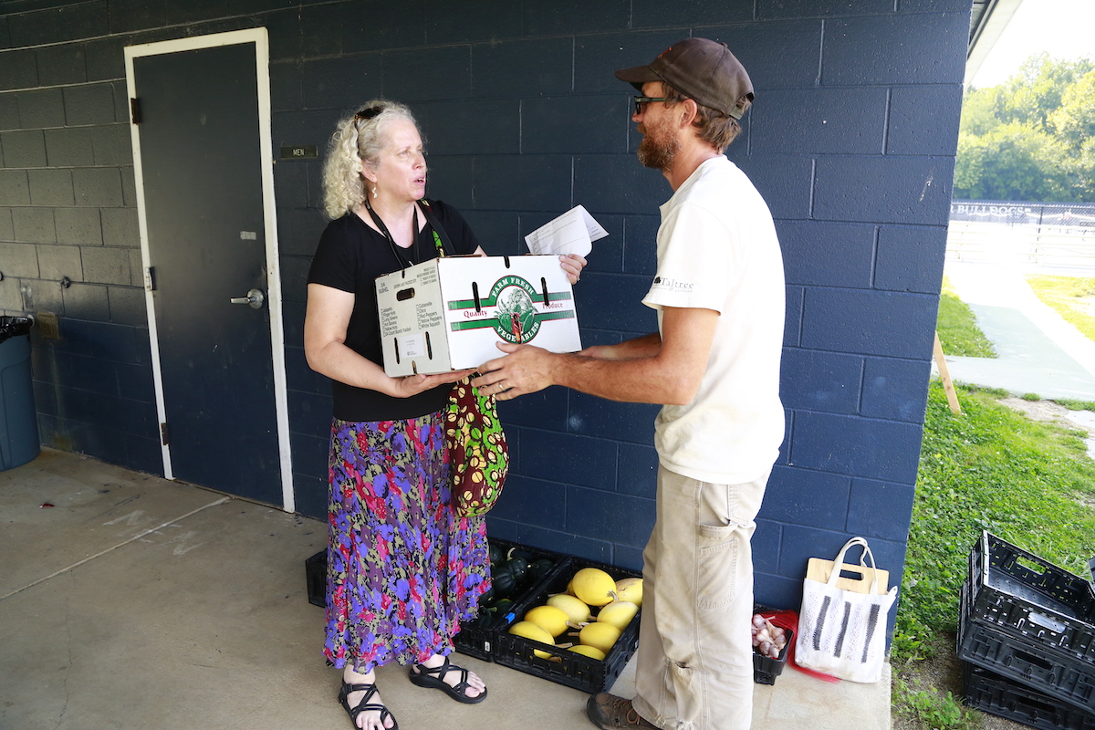 BUYING LOCAL: Members of The Farm's Community-Supported Agriculture Program can pick up pre-assembled boxes of produce each week—a bit like a food subscription service.