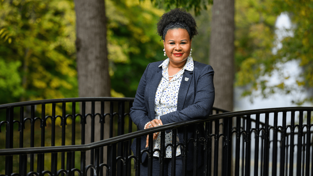 portrait of Khalilah Shabazz in gray blazer leaning on black railing