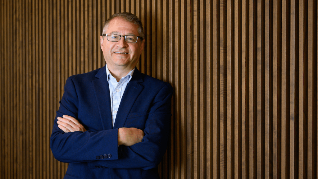 headshot of gary beaulieu in front of wooden wall