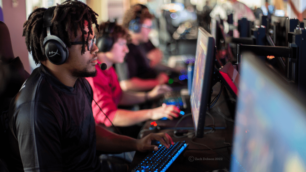 Male student wearing headset and using a gaming computer