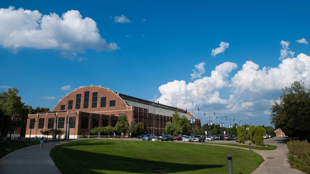 Hinkle fieldhouse brick building with blue sky and white clouds above