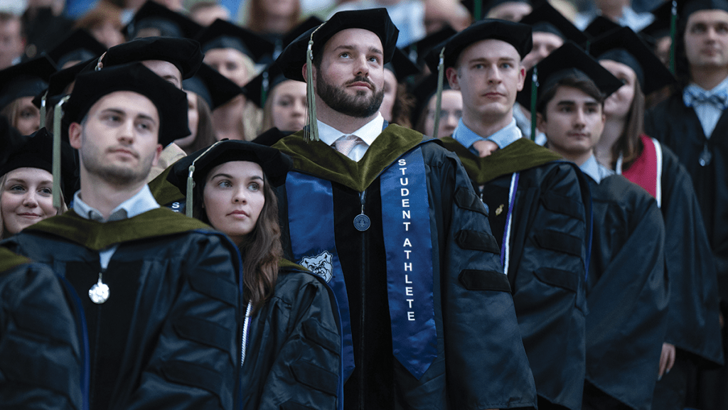 Group of male and female students at Commencement in black regalia
