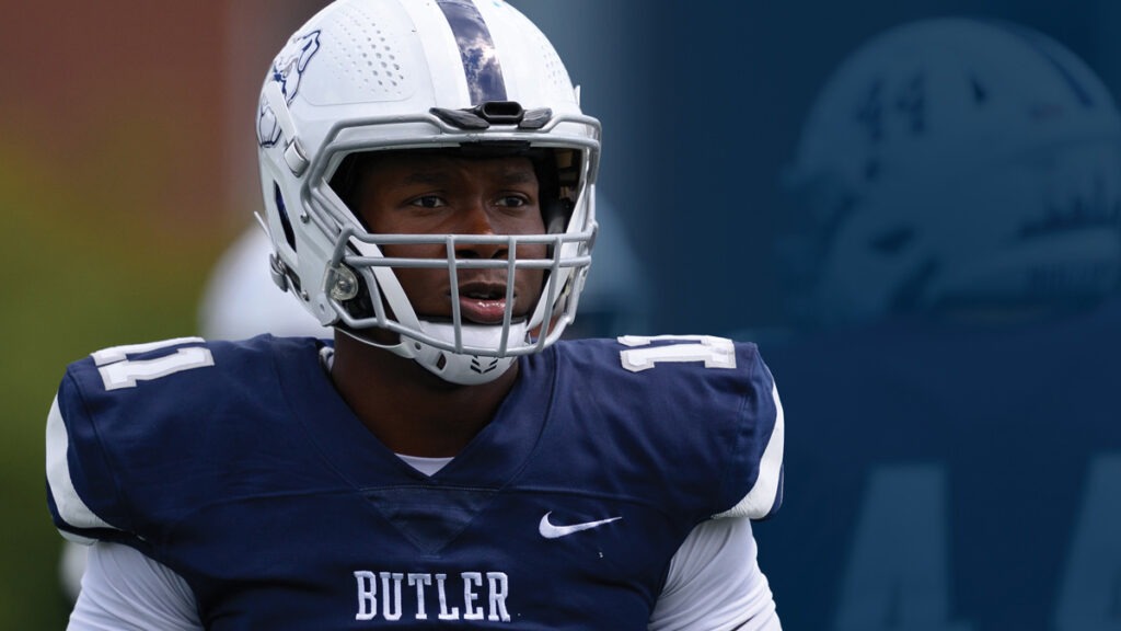 Butler football player Steven Williams II in football uniform looks across the field.