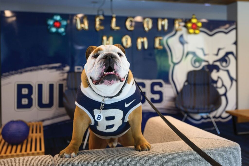 Butler Blue IV on Butler University's move-in day in front of a welcome sign for new students