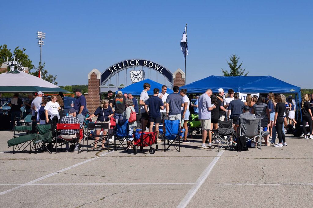 Crowd of Butler University alumni tailgating outside the Sellick Bowl football stadium.