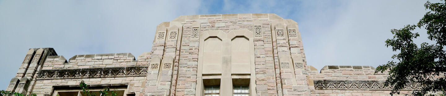 front of beige limestone building