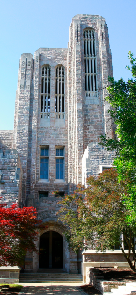 Limestone brick Jordan Hall entrance with autumn trees in front.