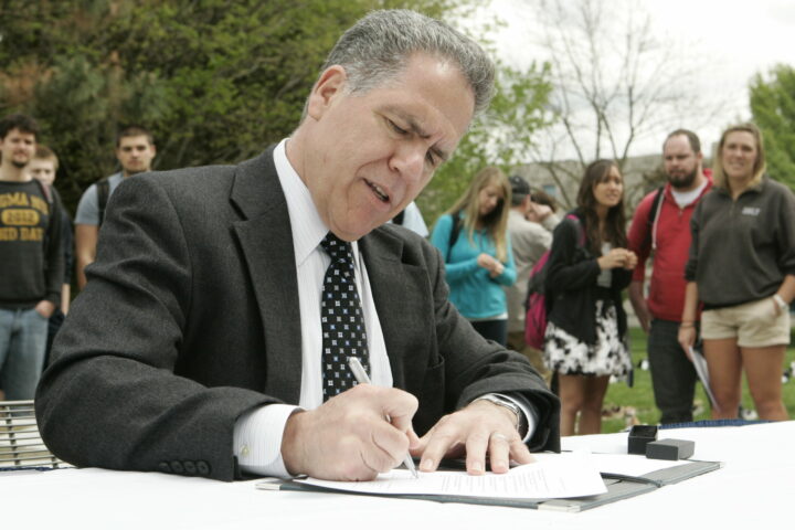 President Danko signing the American College & University Presidents’ Climate Commitment.