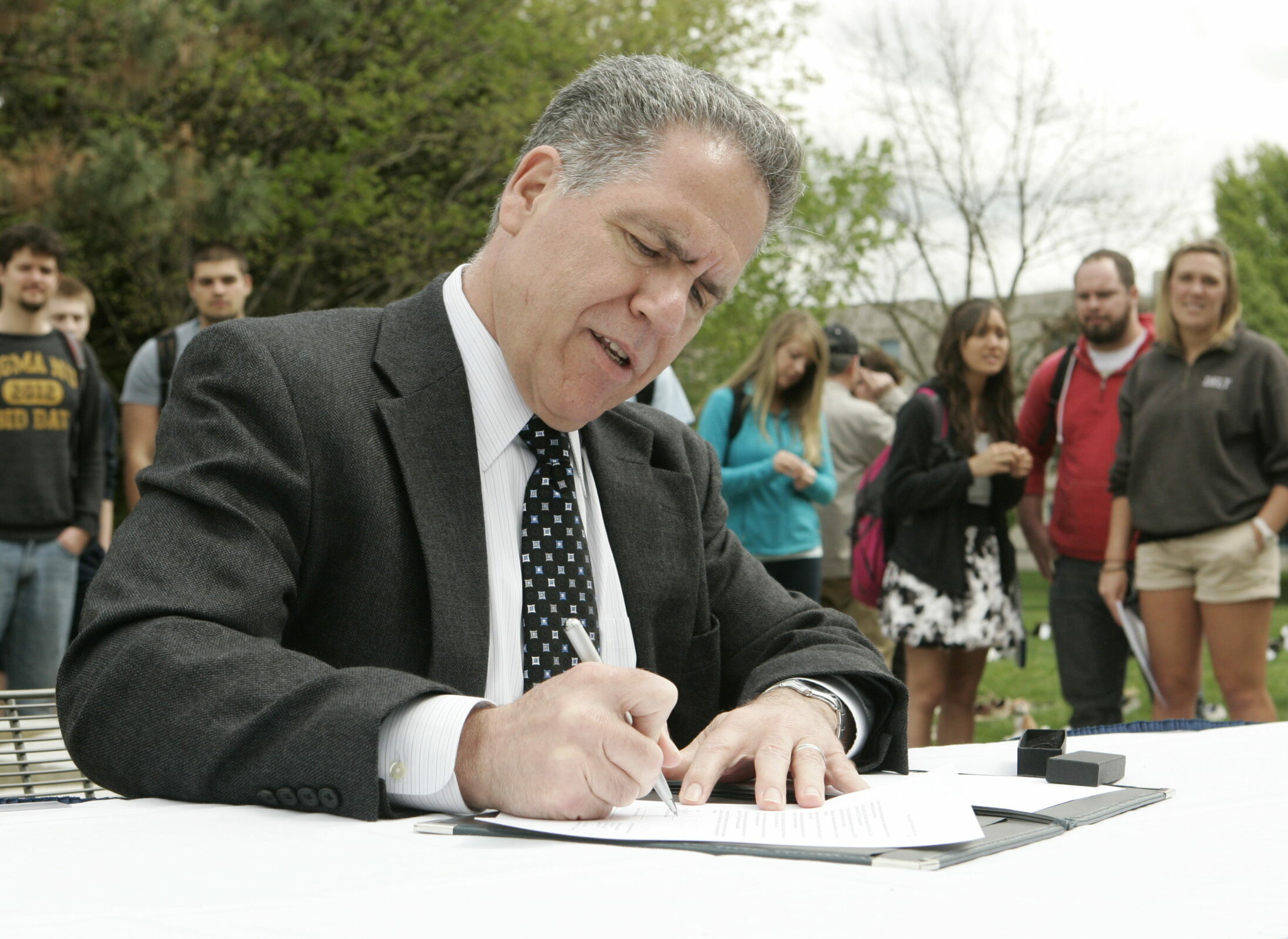 President Danko signing the American College & University Presidents’ Climate Commitment.