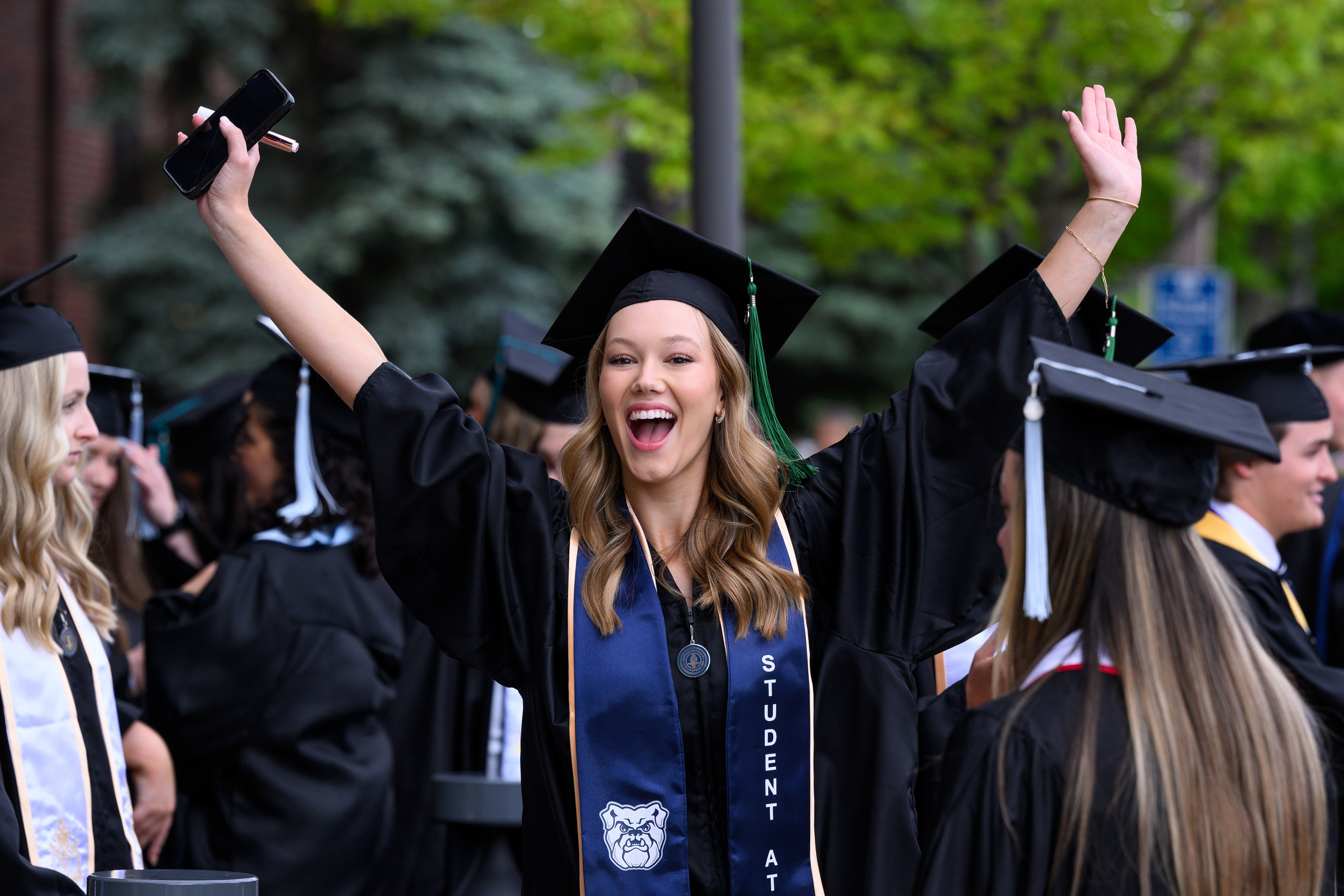 Female Butler graduate excited at Commencement ceremony.