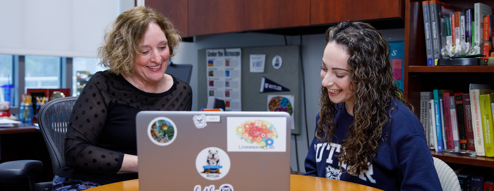 Female Butler faculty member talking to a female Butler student.