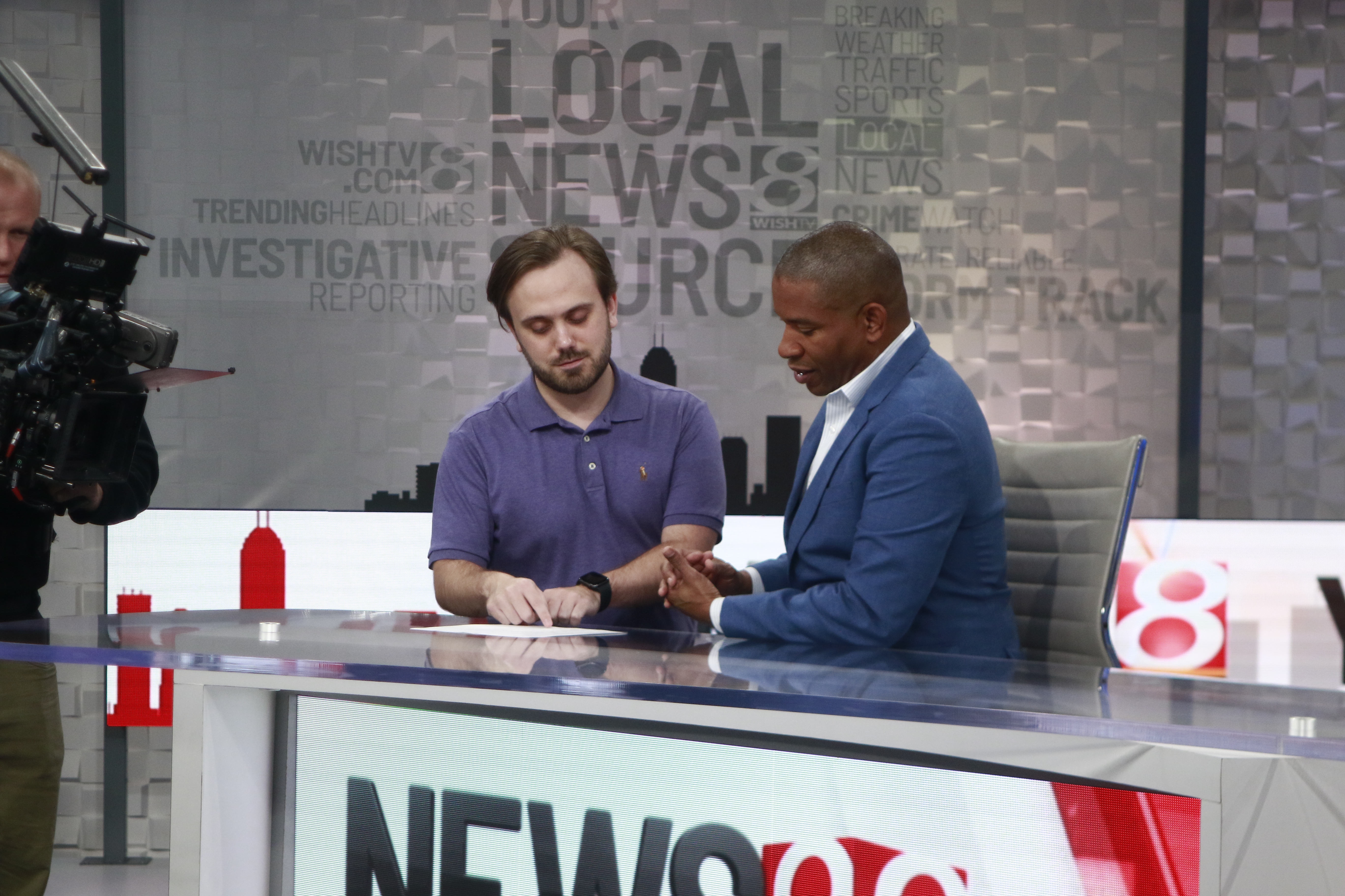 Male student intern at WISH-TV Indianapolis in news desk.