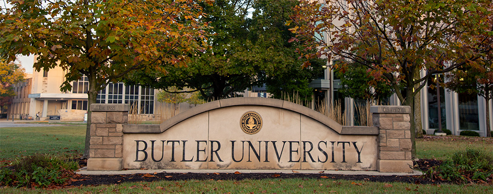 Stone wall with the words "Butler University" inscribed on it.