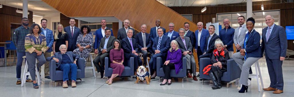 Group photo of the Butler University Board of Trustees in the atrium of Dugan Hall.