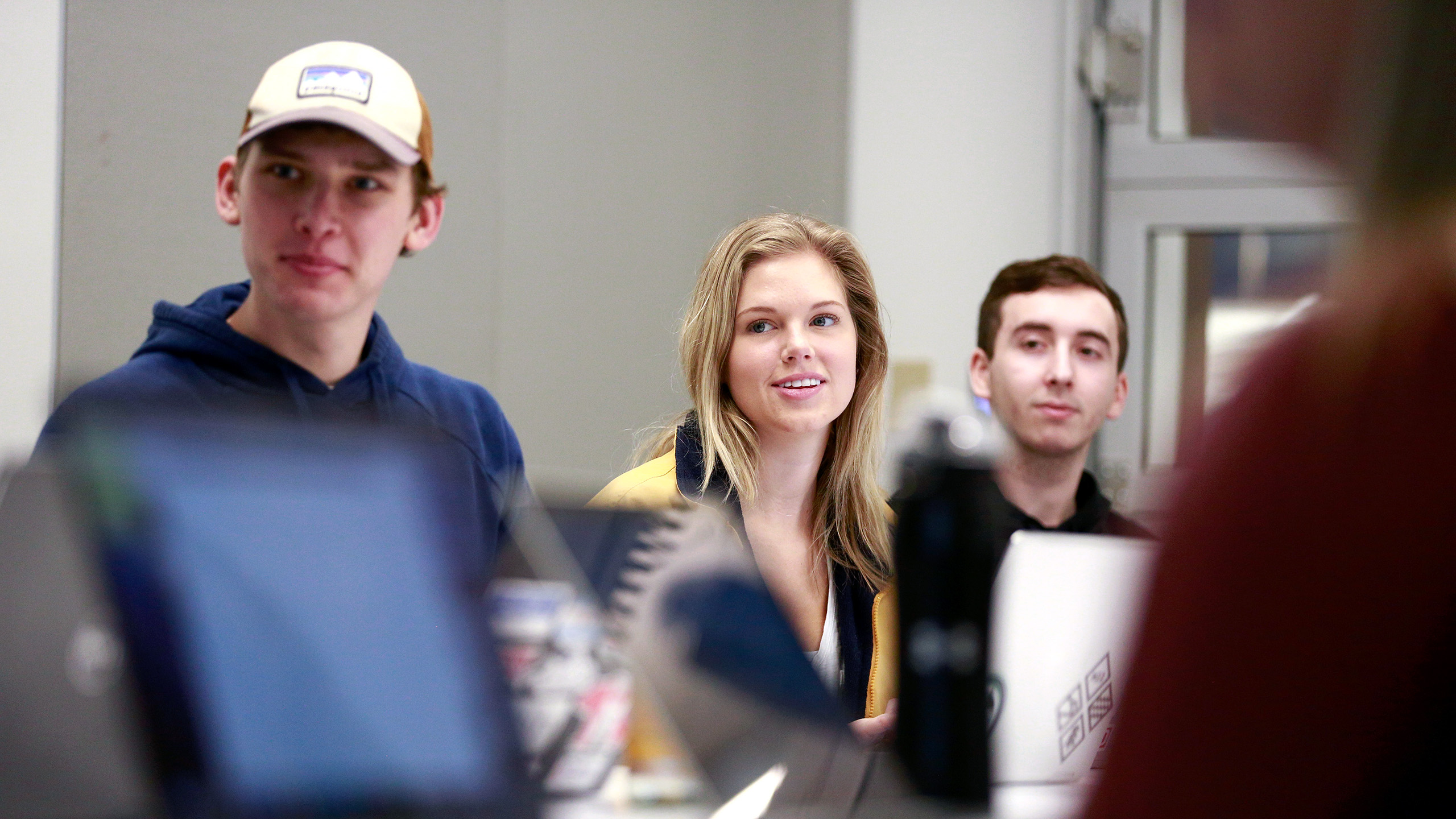 Insurance students look at speaker at end of table.