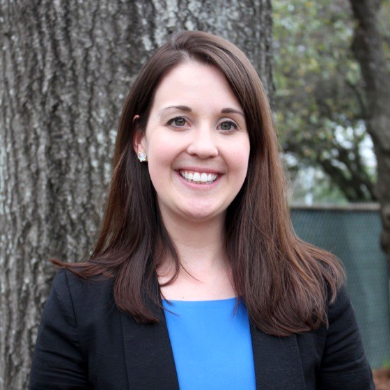 Lindy Powell smiles in a black blazer.