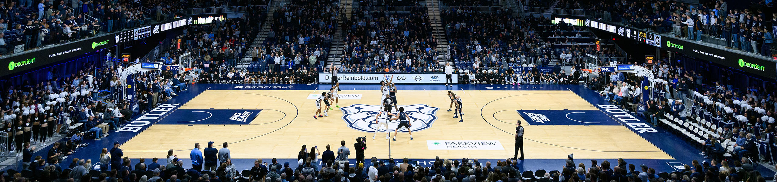 Crowd cheers for tipoff of basketball game inside Hinkle Fieldhouse.