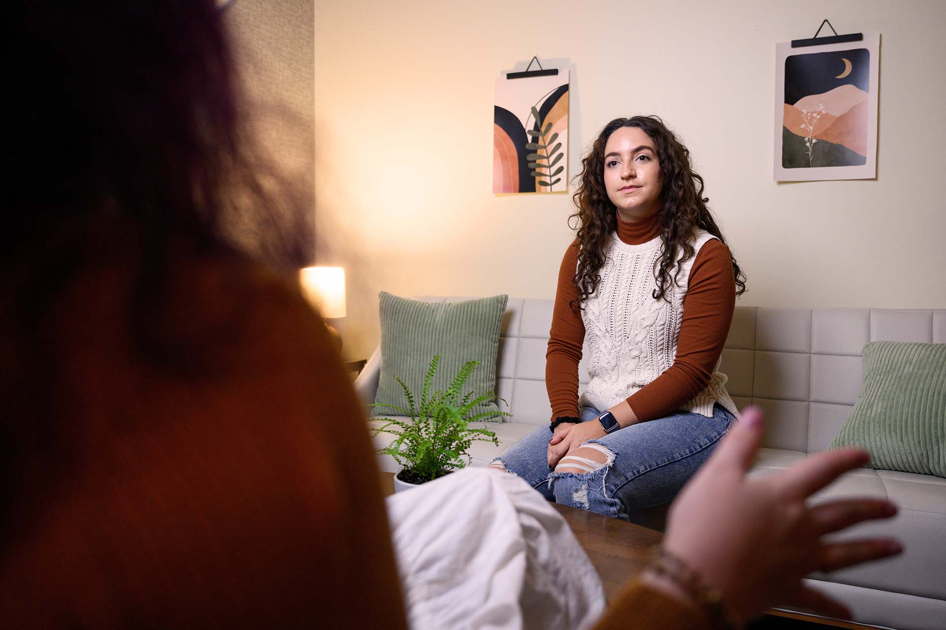 A staff member consults with a student in a counselor's office.