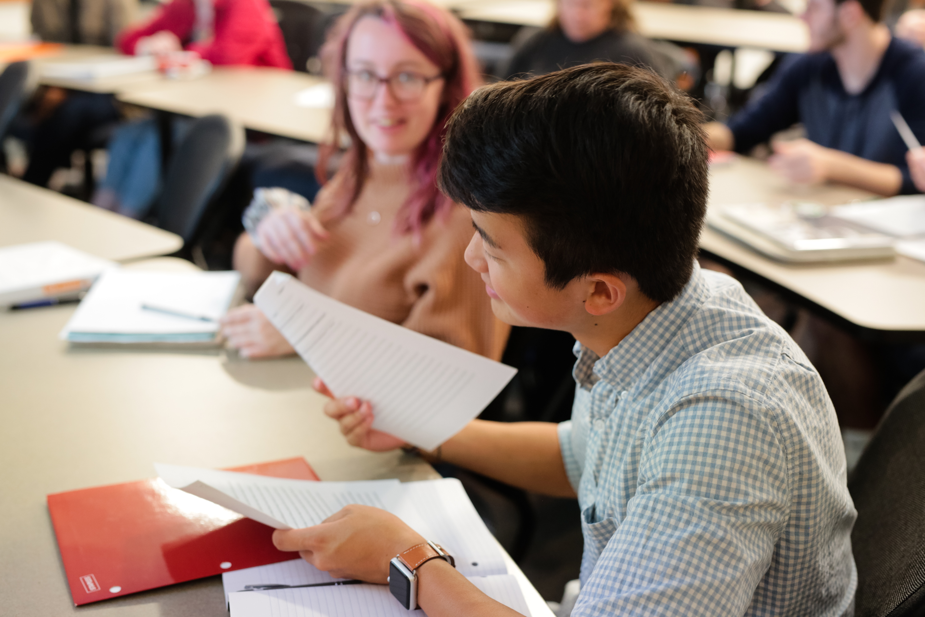students in the classroom looking at notes