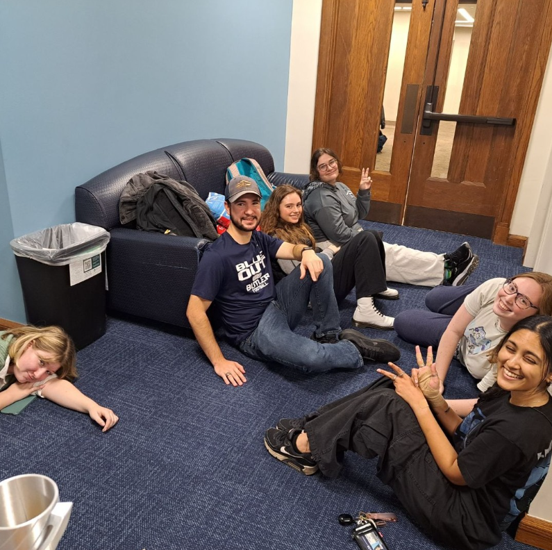 Students sitting on the floor of the CSSE office suite