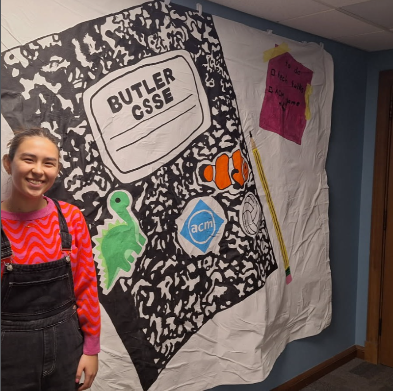 Student Sarah Norville showing the CSSE banner she made for us