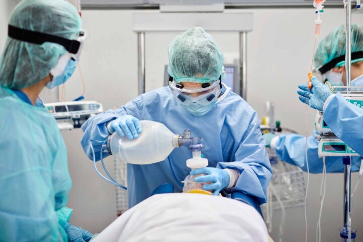 Medical professionals intubate patient in the intensive care unit (ICU).