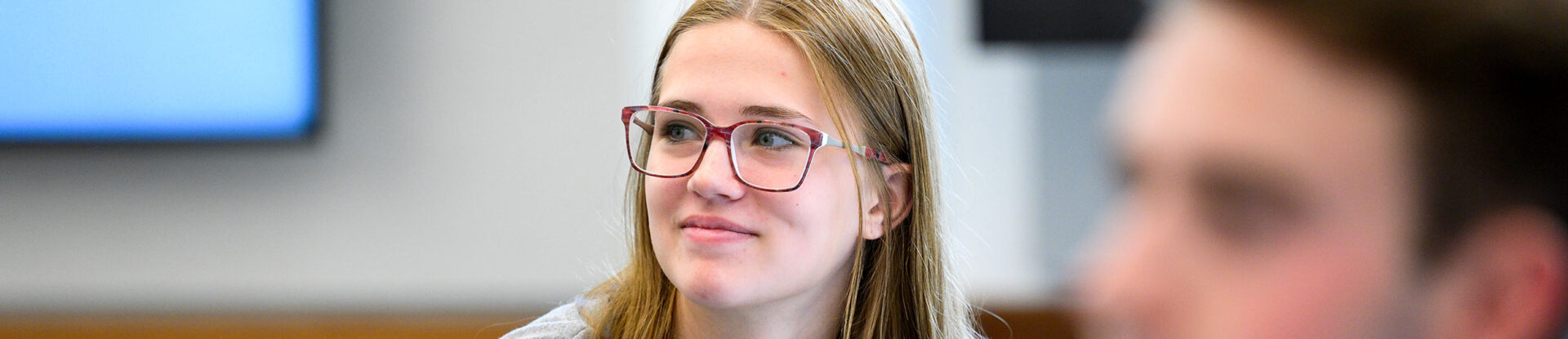 Butler student smiles while professor is teaching.