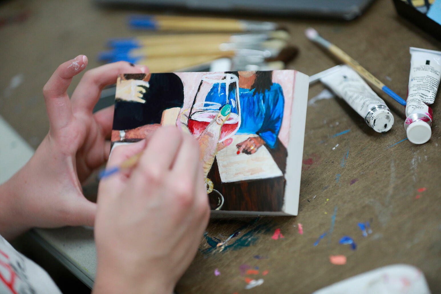 student painting a canvas