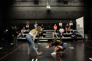 Students practicing in a blackbox theatre