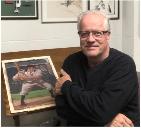CF Payne at his drawing table with an illustration of a baseball player at bat.