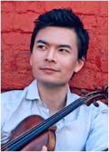 Stefan Jackiw holding violin.