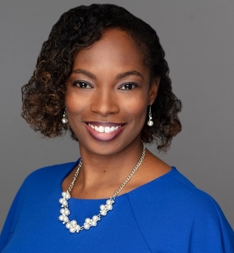 MSRI alumna Tabitha Richardson smiling with blue shirt and white necklace.