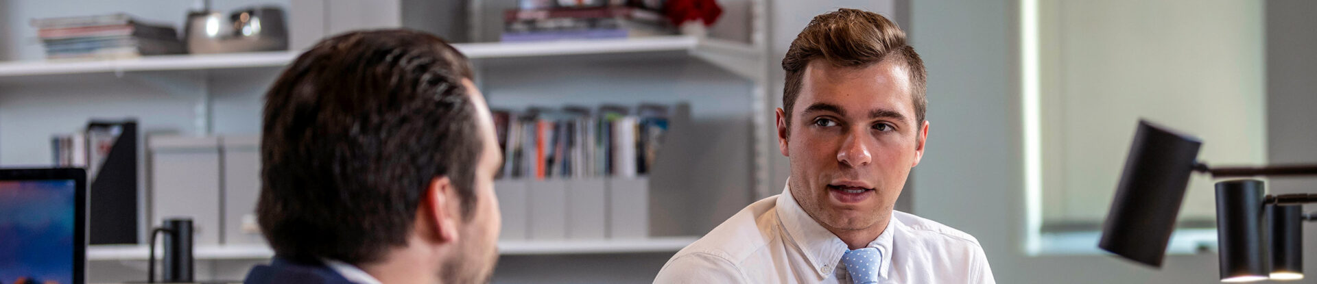 Two male analytics students talking. One is facing forward and