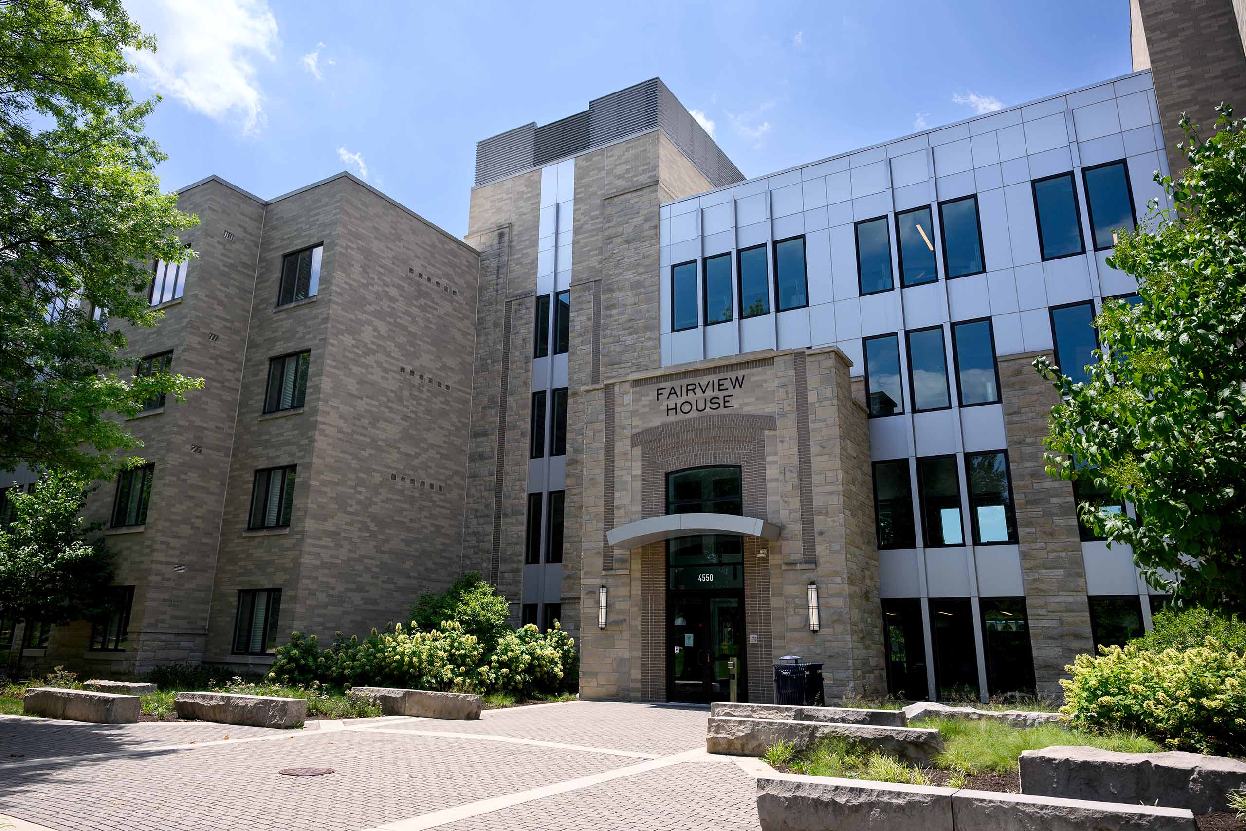 Limestone exterior with windows of Fairview House dormitory by the main entrance courtyard.