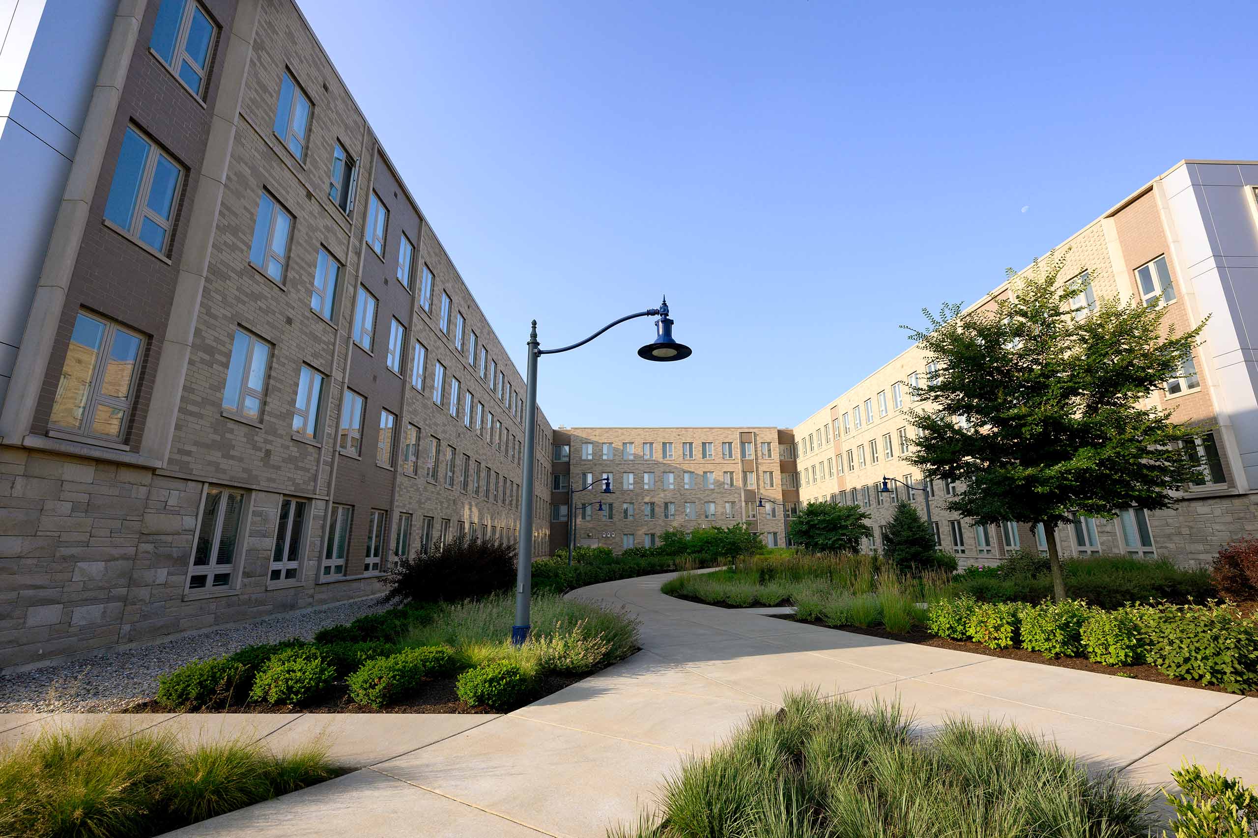 Irvington House dormitory with hundreds of windows that overlook criss-crossing paths and greenery.