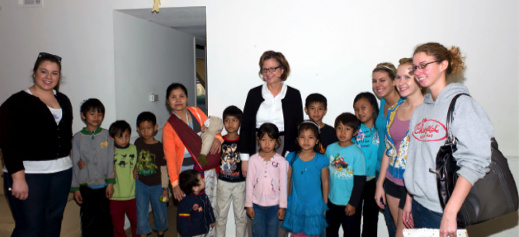 Group of adults and children pose for a group photo as part of the CCC Community Partnerships program.