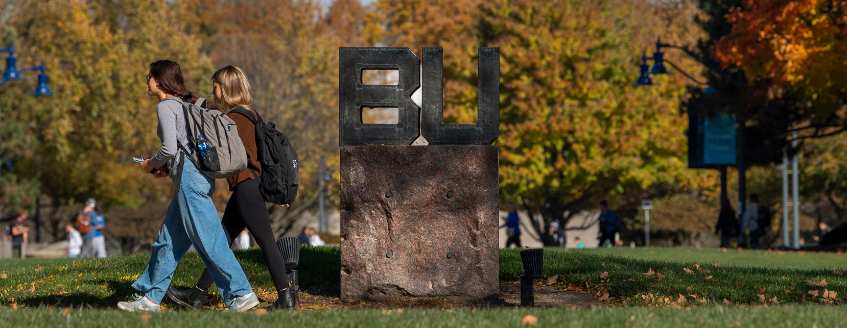 students walking in front of BU sign