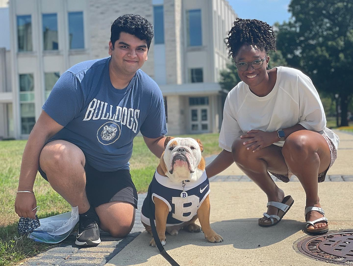 Current Butler students posing with Butler Blue IV.