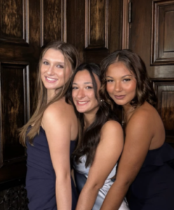 three members in formal dresses