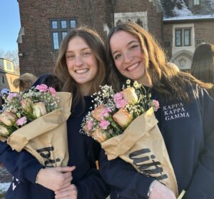 two members, holding flowers, from big little event
