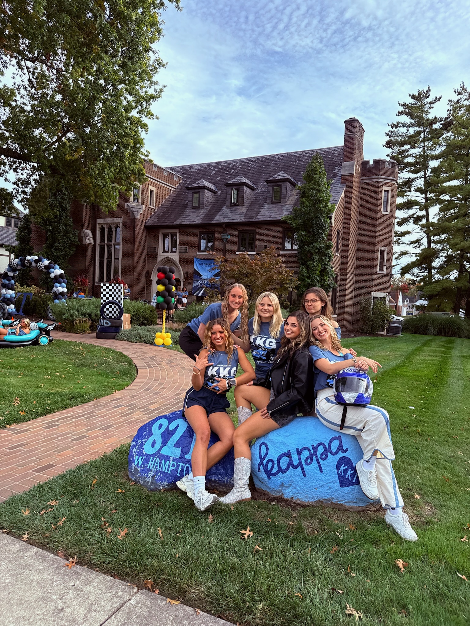 6 sorority women on rock outside of house