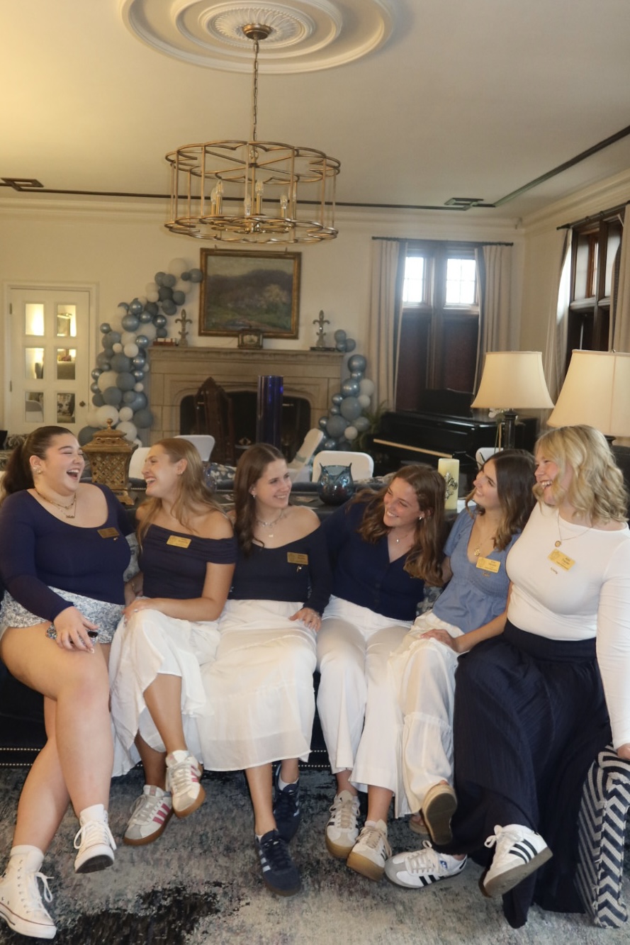 Six women laughing in the living room