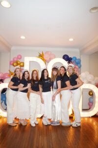 6 women during recruitment, in front of Do Good sign