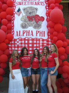 5 sisters in front of Sweetheart banner