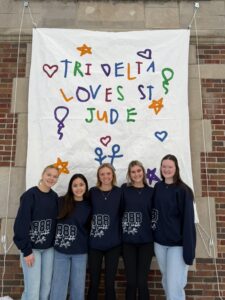 5 sisters in front of St Jude banner