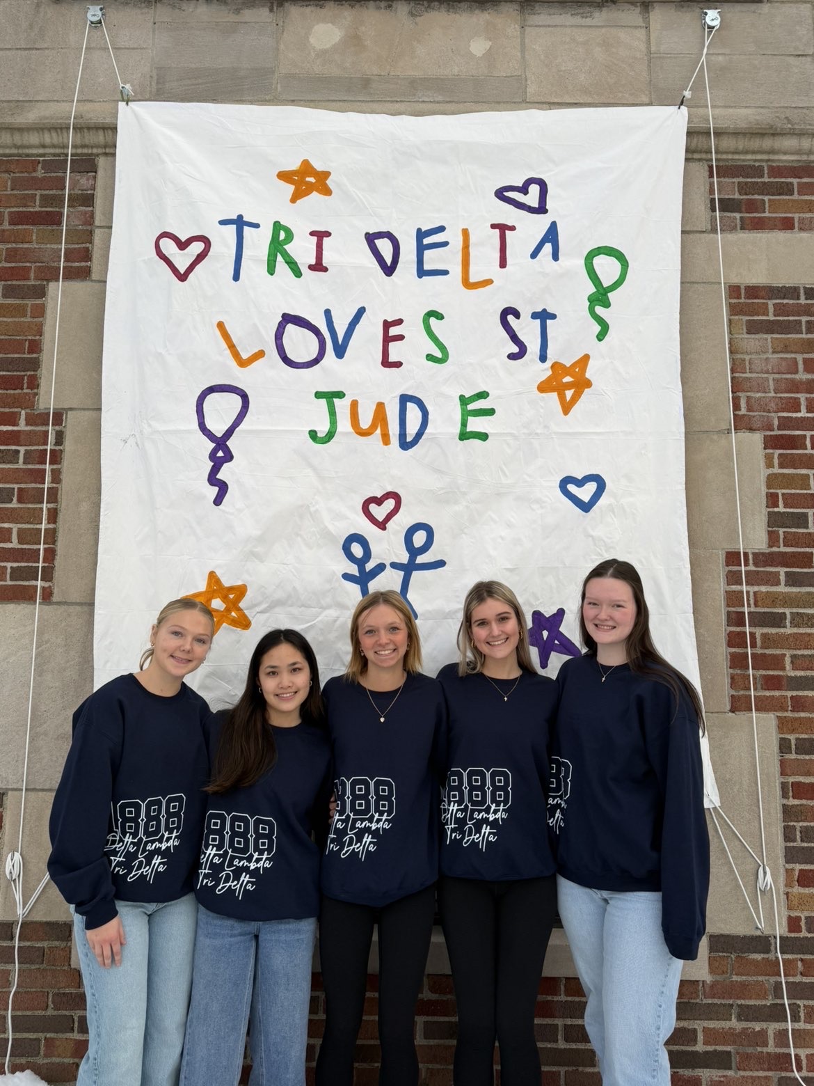 5 sisters in front of St Jude banner