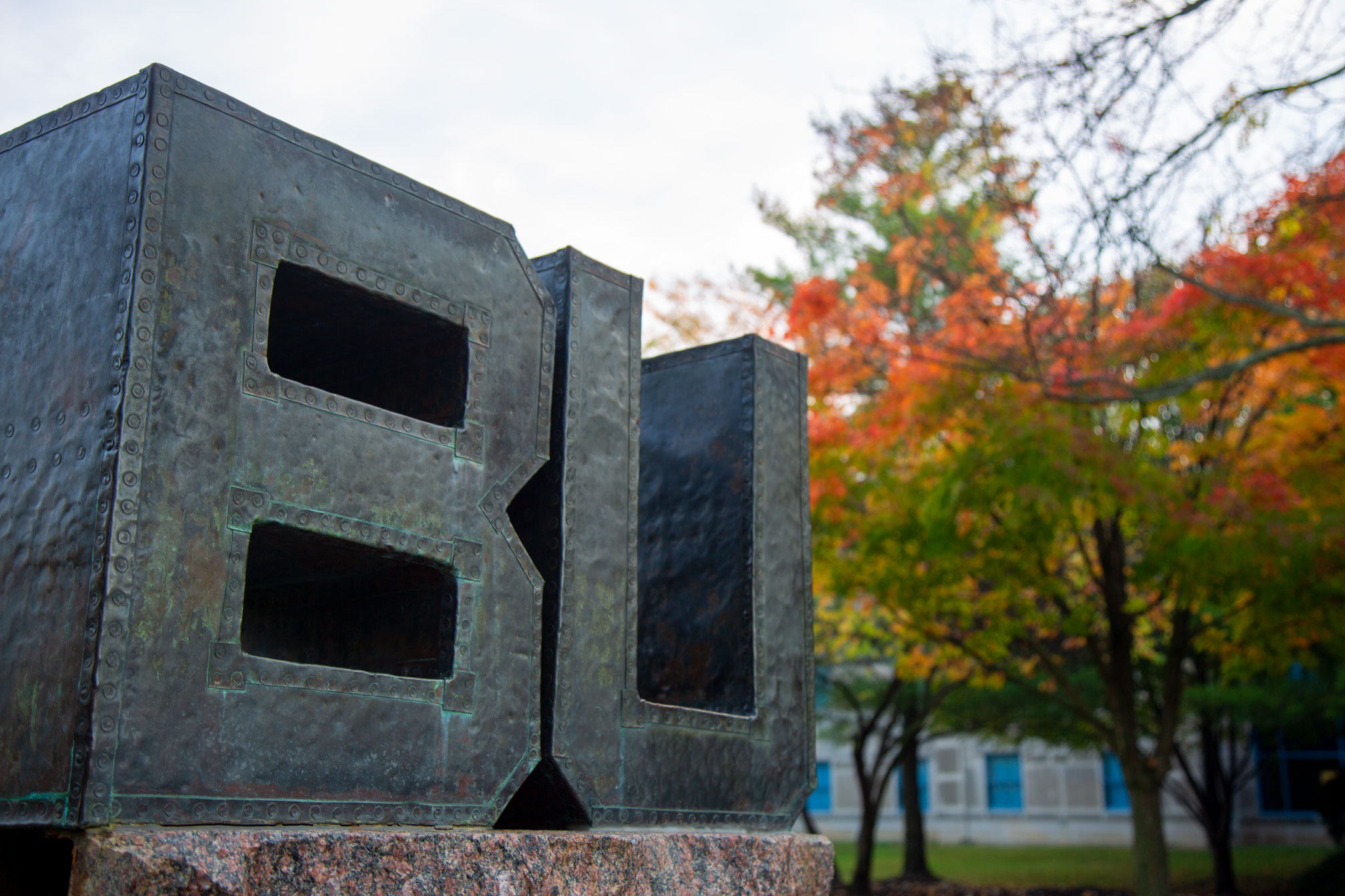 Metal "BU" letters art installment on campus