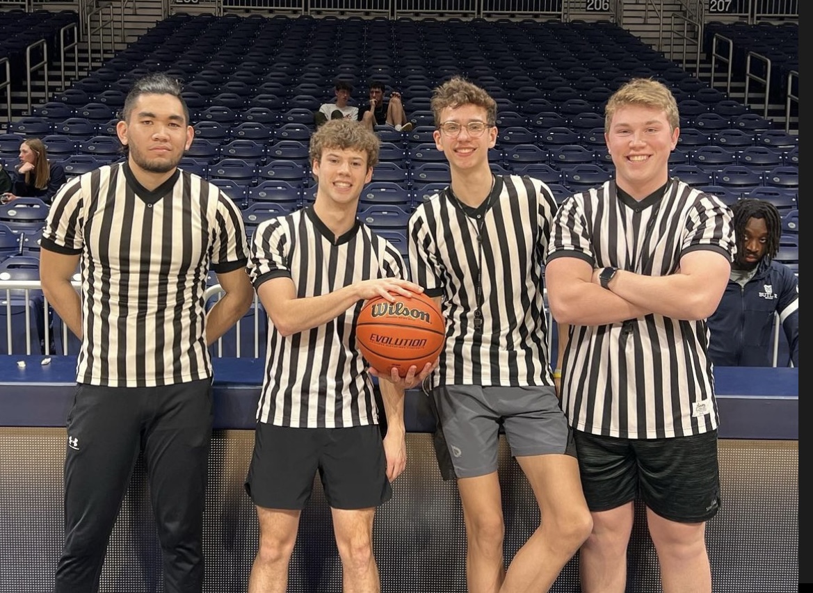 4 males in sports official striped shirt