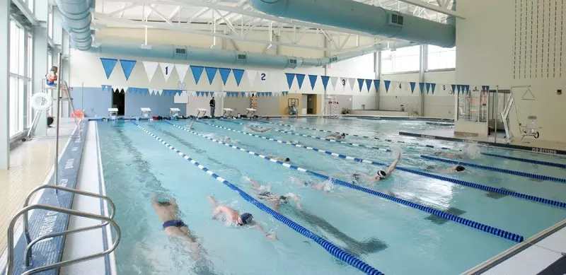 Two people per lane swimming in the Butler Health and Recreation Complex pool.